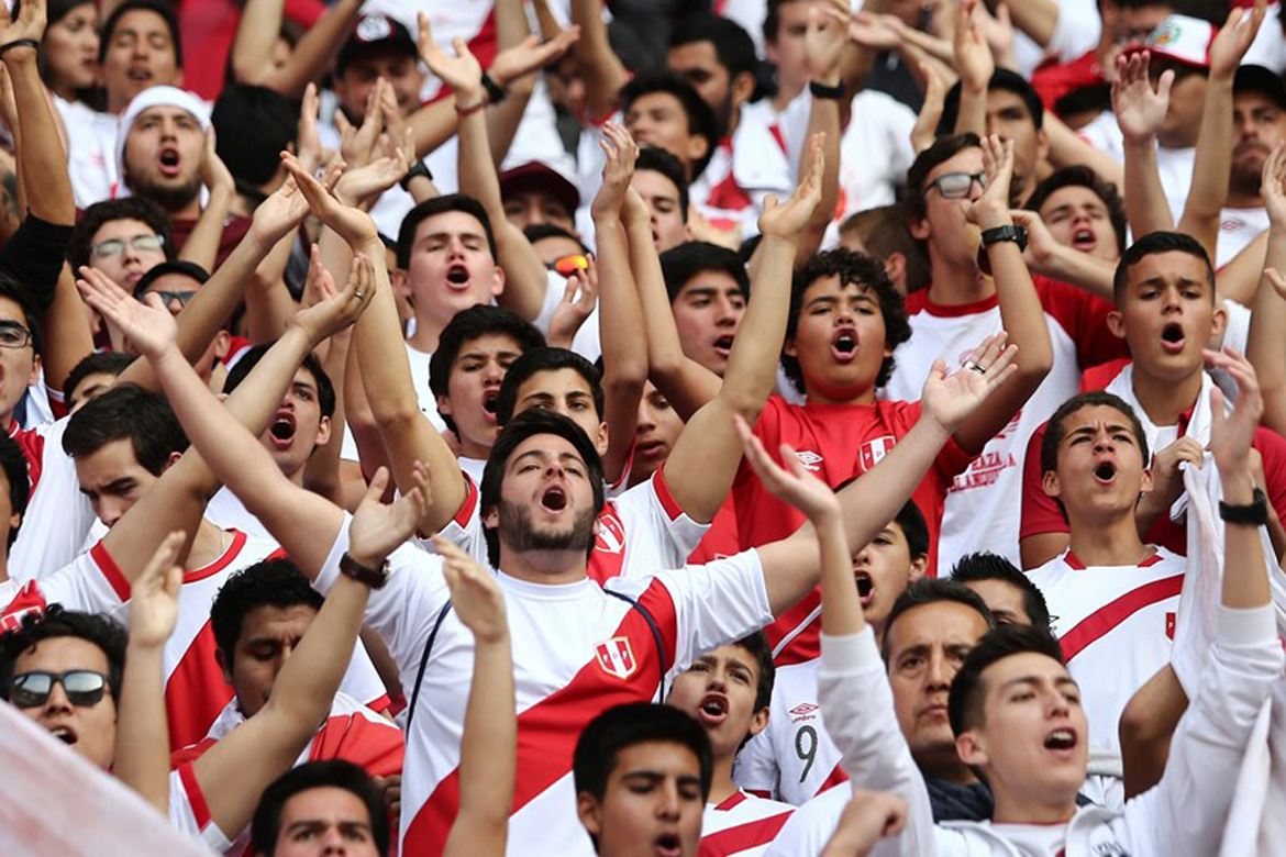 Fans of Peru cheer their team prior to a match between Peru and Colombia. 